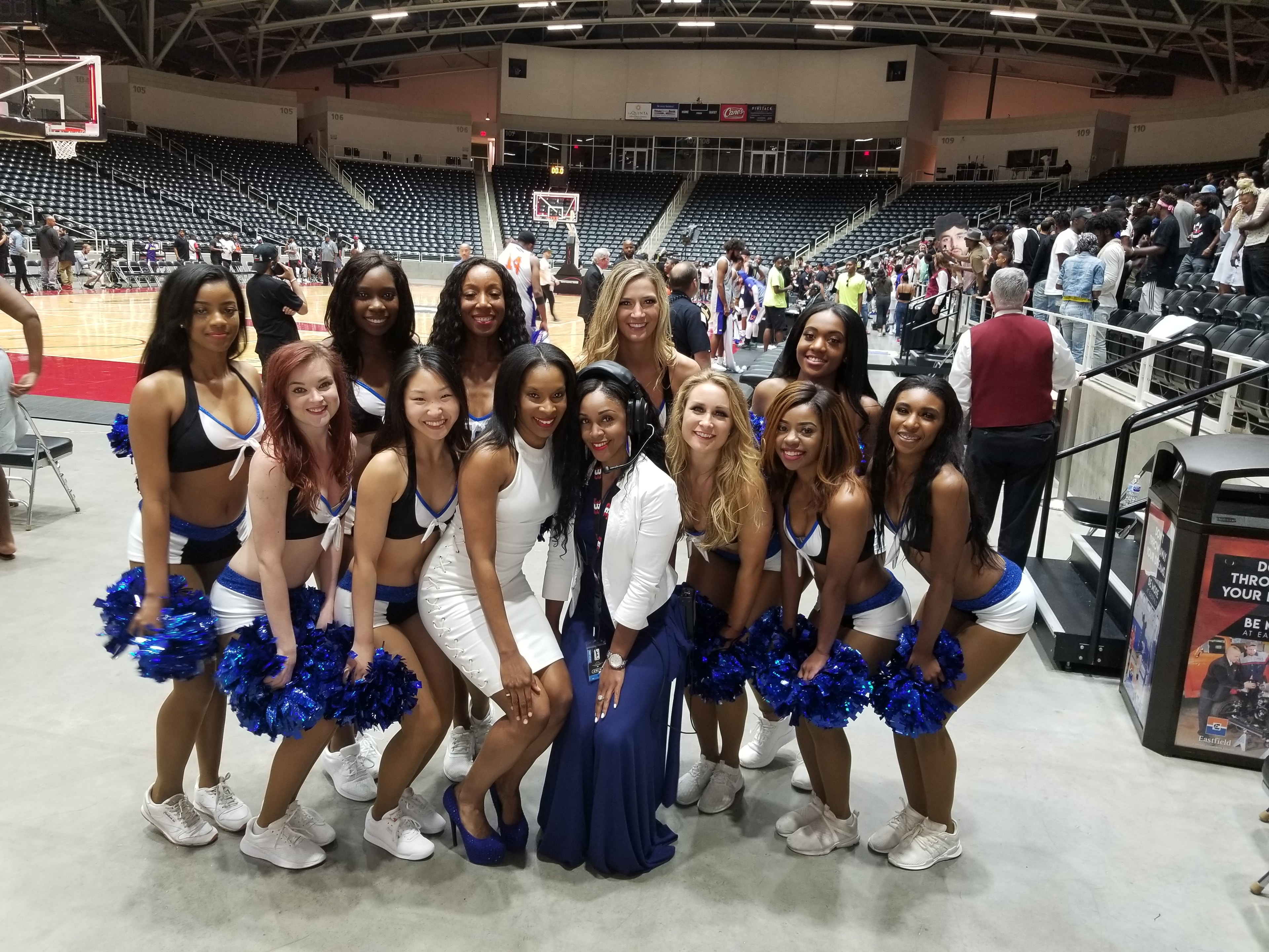 JBA squad photo at basketball arena in blue and white uniforms
